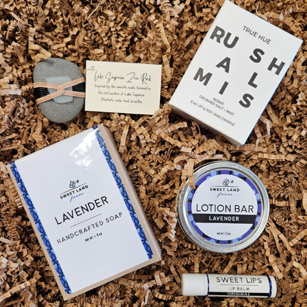 Sweet Lips Lip Balm, Lavender Lotion Bar, and Handcrafted Lavender Goatmilk Soap from Sweet Land Farm in Cloquet, Crushed Salt and Mist Candle from True Hue Co., and a Lake Superior Zen Rock by artist Rita Walker